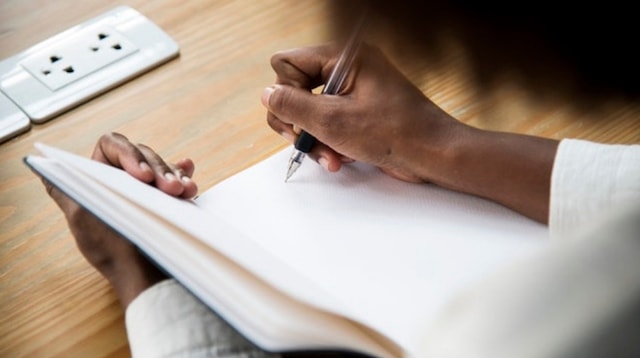 Website Design Woman Jotting Notes in Notebook