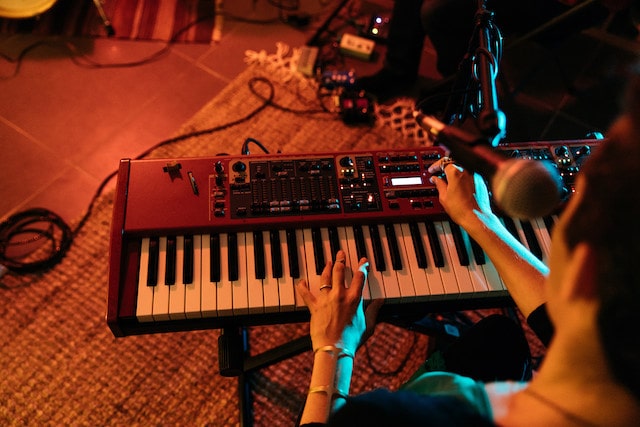 Woman playing keyboard in a music studio