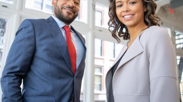 Business Man and Woman Standing in an Office Building