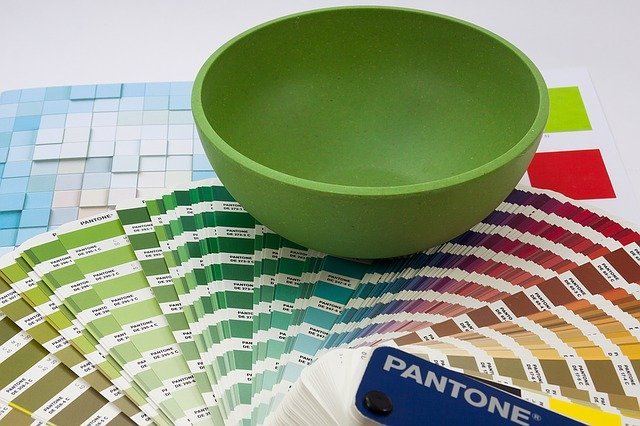 Green Bowl Sitting on Top of Colour Swatches