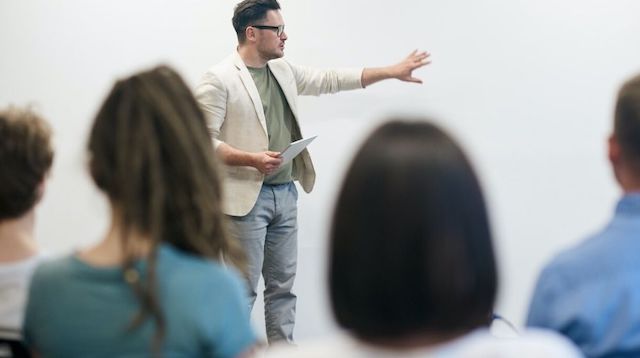 Man in Beige Blazer Making a Presentation