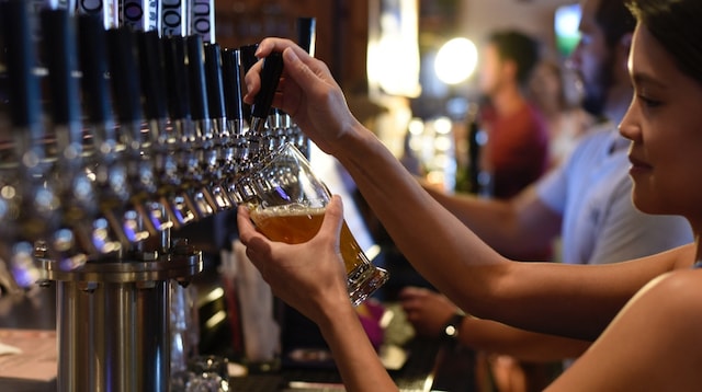 Finding Businesses for Sale Woman Pouring Beer