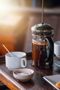 French Press Coffee Maker Sitting on Wooden Table