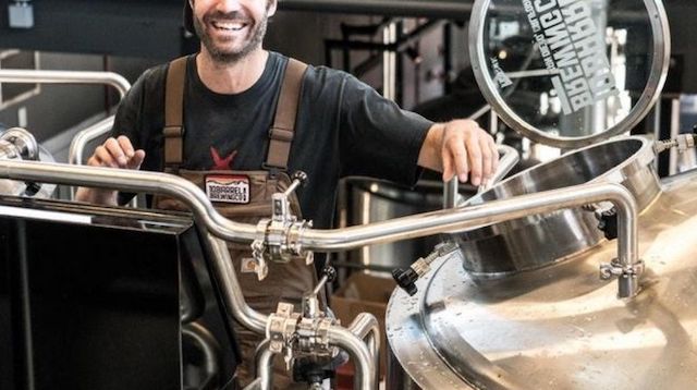 Man Standing on Brewery Floor Near Open-Vat