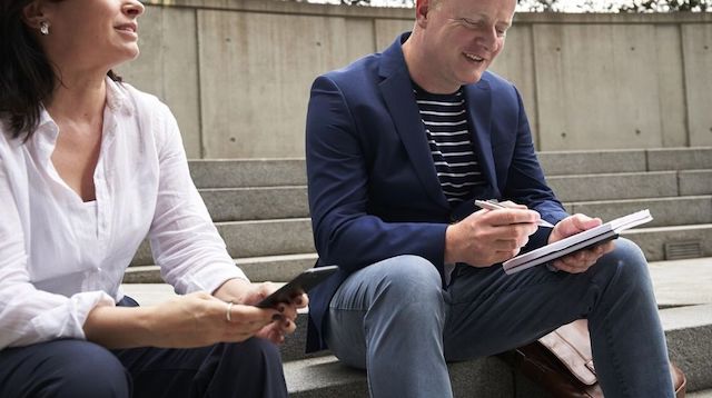 Management Consulting Woman and Man Talking on Bench