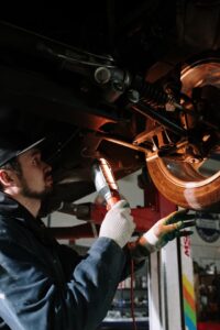 mechanic-looking-at-the-underside-of-a-car.jpg