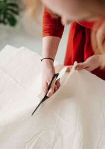 Patent Woman in Red Cutting Fabric