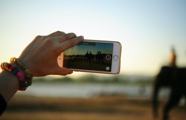 Person Shooting a Video with Her Smartphone