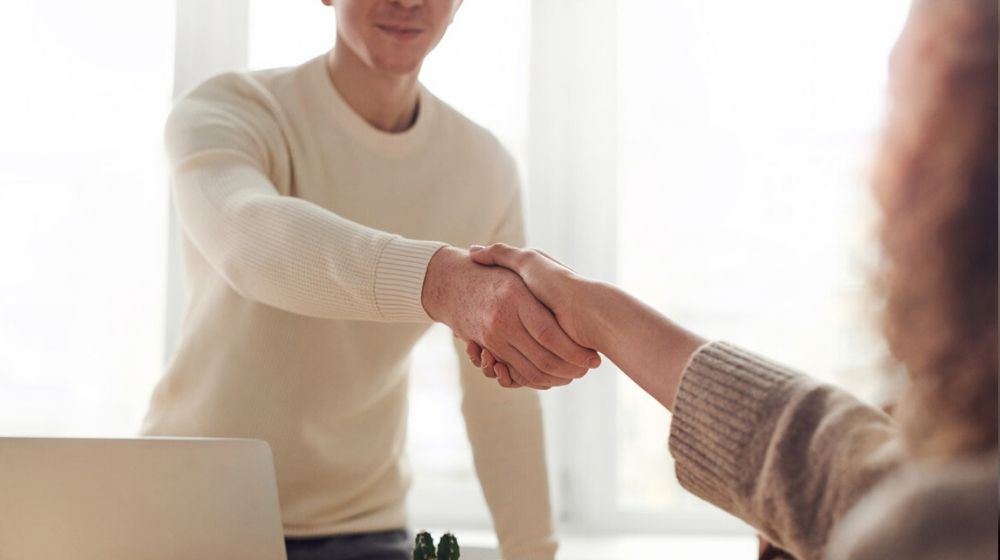 Web Design Company Man and Woman Shaking Hands