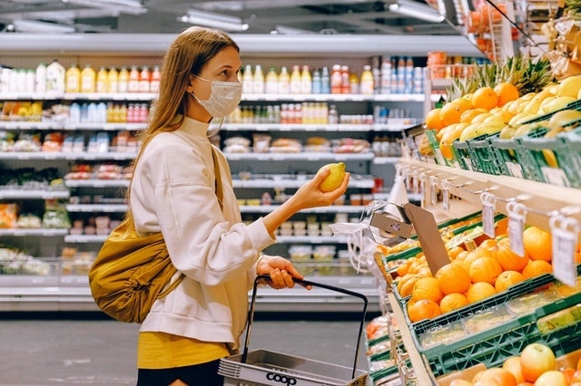 Woman Wearing Mask While Shopping in Grocery Store