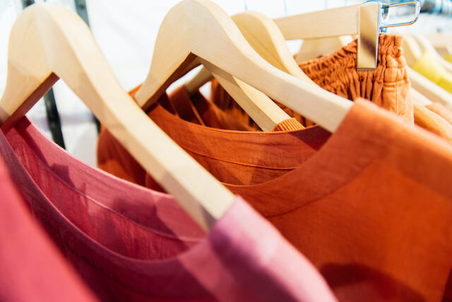 Colorful clothing hanging on a rack.