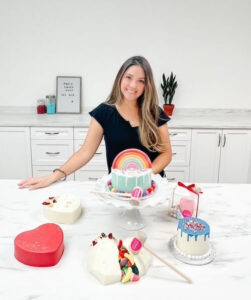 Stephanie posing with her cake creations