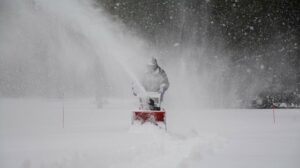 Business Ideas in Canada Person Snow Blowing a Sidewalk