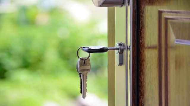 Close up of keys hanging from a door lock