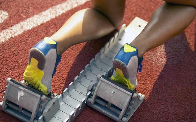 Close-up of runner’s feet in starting blocks