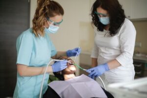 Dentist and hygienist working on a patient