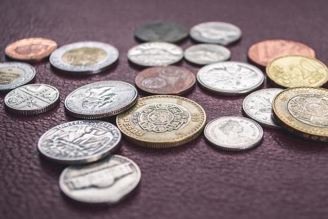 Global coins spread out on table