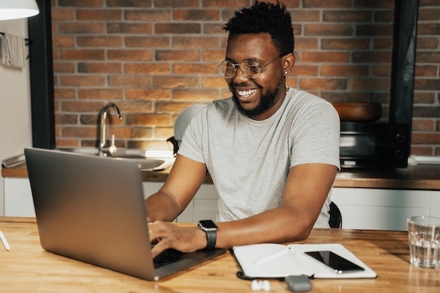 Man working on a laptop in his kitchen