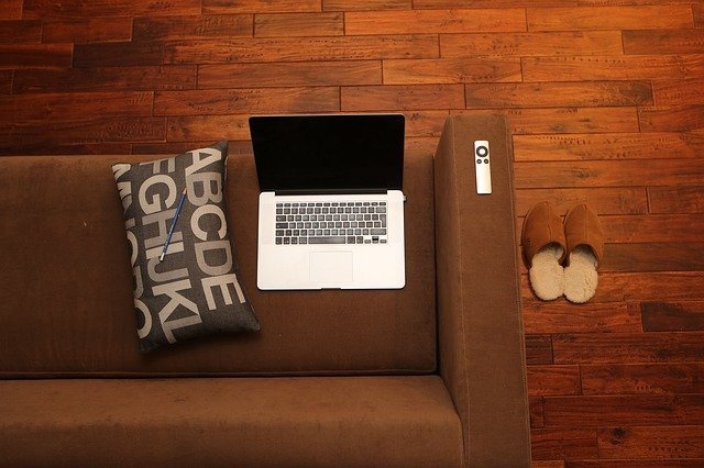 Overhead view of a couch with slippers beside it