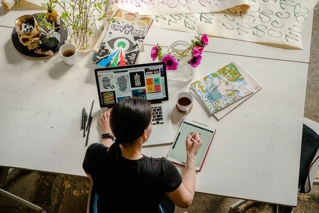 Overhead view of graphic designer working at a table