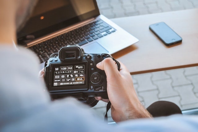 Person holding a digital camera