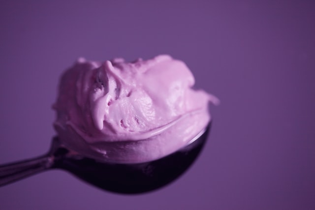 Scoop of ice cream against a purple background