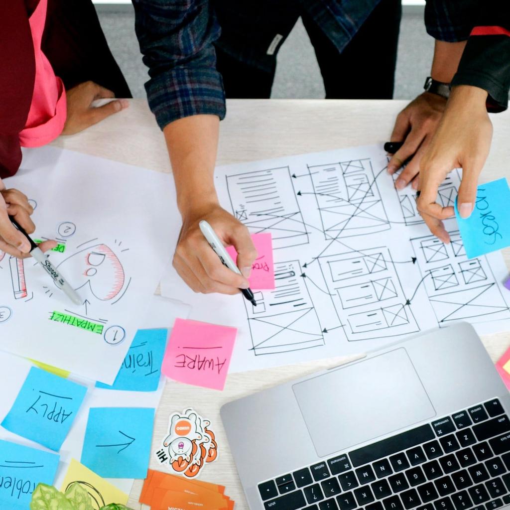 Three web designers working with user experience sketches