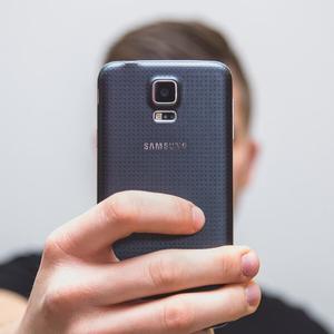 Man recording a testimonial with a smartphone