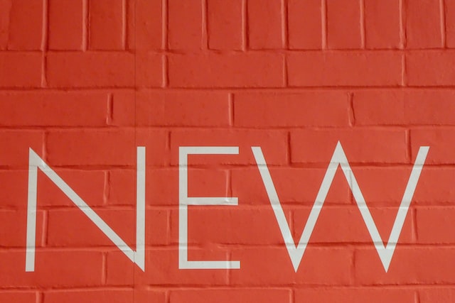 The word new written on a red wall