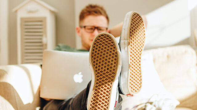 Man sitting on couch with a laptop