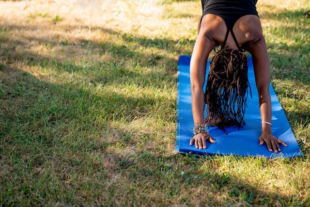 Woman doing down dog on a yoga mat