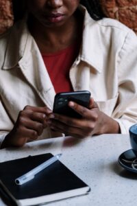 Woman scrolling through her social feed in a cafe