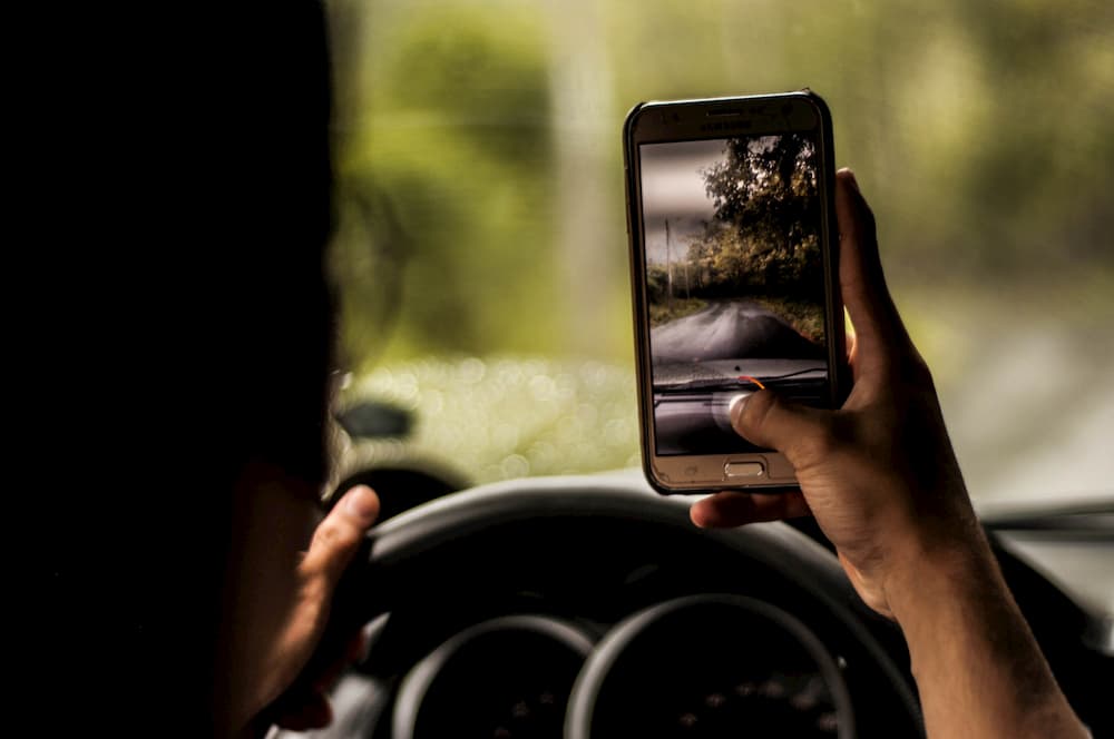 Imagen de un hombre sacando una foto desde dentro de su coche.