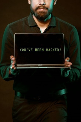 Man holding sign that says “you’ve been hacked”