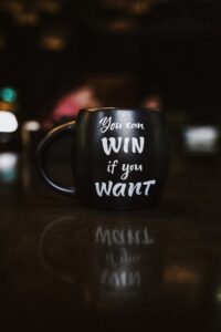 Black mug with 'You can win&quot; printed on it