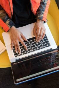 Person Viewed from Above Typing on Laptop