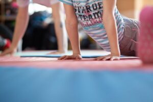 Two children doing yoga