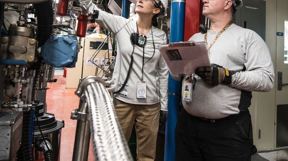 Two people looking at machinery