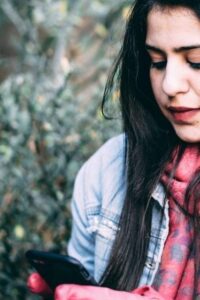 Woman Outdoors Looking at Her Smartphone Screen