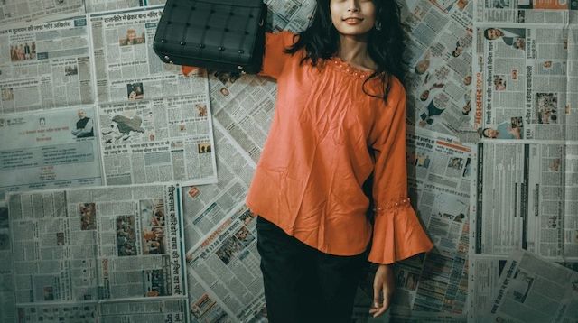 Young woman in an orange blouse modeling