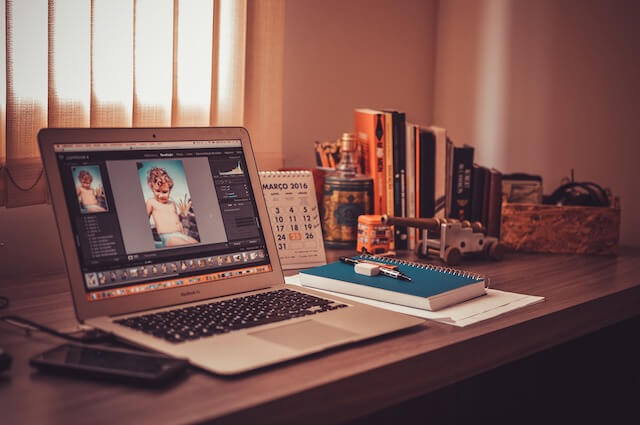 Desk with open laptop and notepad