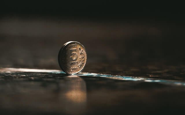 Close up of a Rs 5 coin standing on its edge