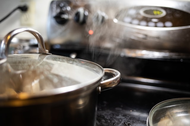 Covered pots cooking on a stove