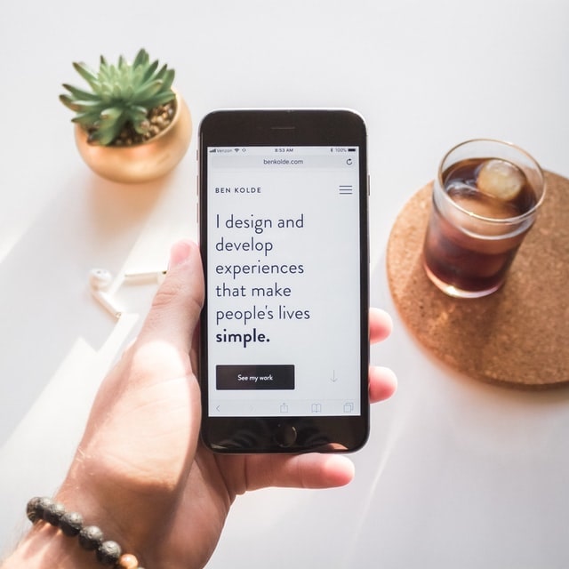 Designer holding a smartphone with a message on the screen