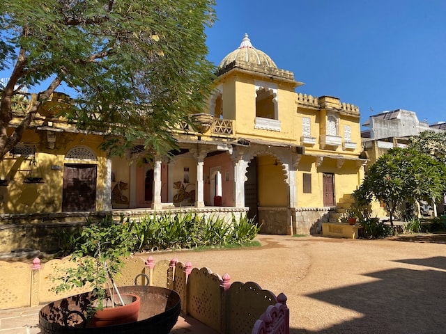 Large yellow house with shaded veranda