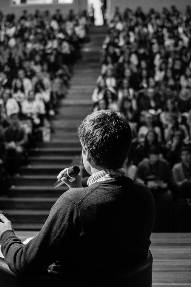 Man addressing a live audience