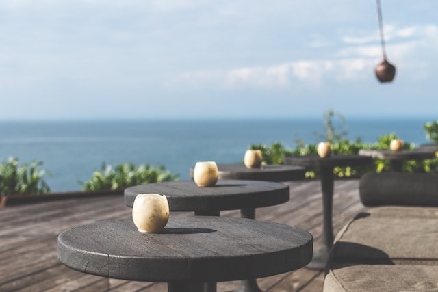 Modern outdoor dining area with views of ocean in background