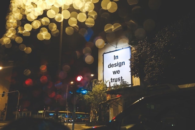 Photo showing a signboard reading "In design we trust"
