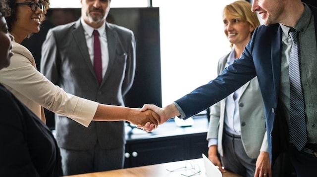 Recruiting Employees Man and Woman Shaking Hands