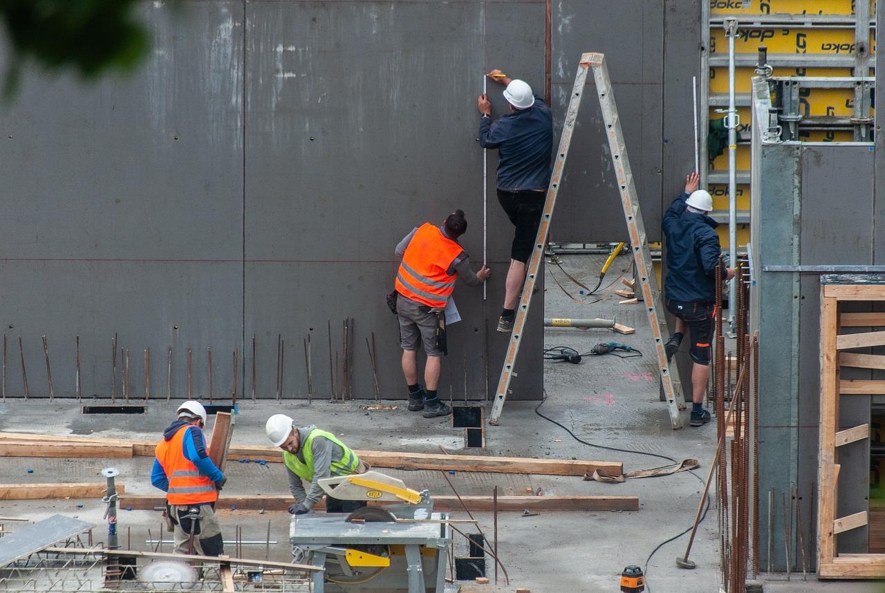 Construction workers on a building site, demonstrating different stages of the building process.